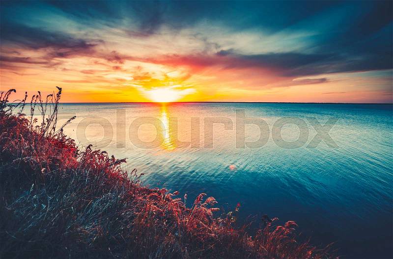 Sunset sky background. Natural Sunset Sunrise Over Ocean. Bright Dramatic Sky And Blue Water. Colorful Nature Landscape, stock photo