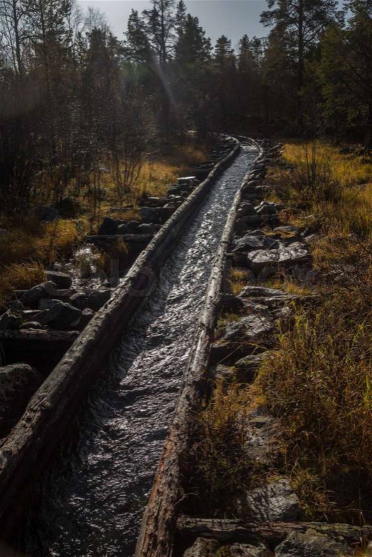 A beautiful autumn scenery of a historic water channel for transporting timber between lakes. Wooden construction. Autumn in Femundsmarka National Park, stock photo