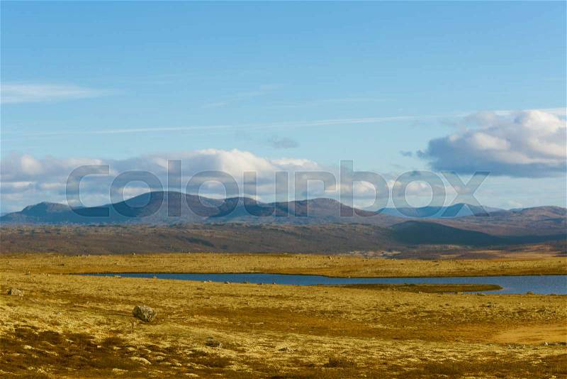 A beautiful mountain lake high above the sea level in Norway. Colorful autumn landscape with lake, stock photo