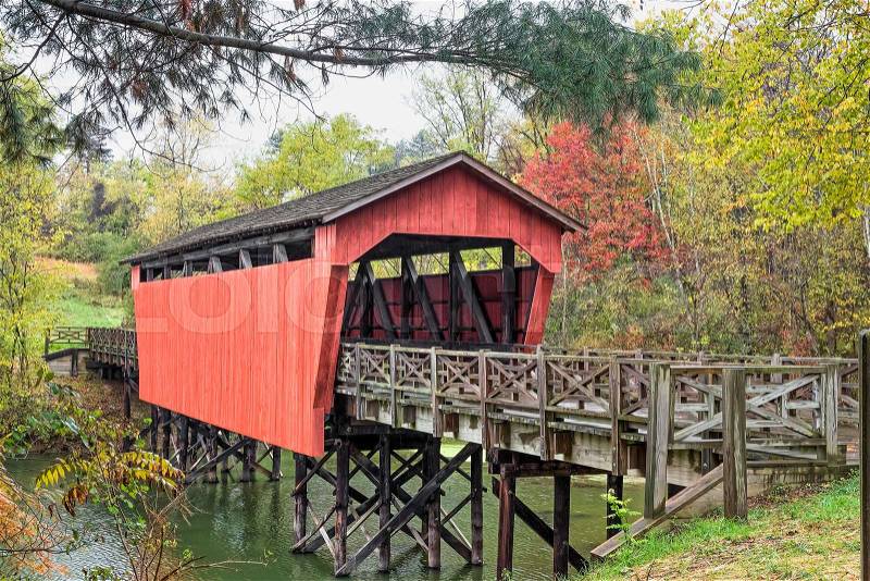 The historic Shaeffer Campbell Covered Bridge crosses College Pond on a campus in St. Clairsville, Ohio, stock photo