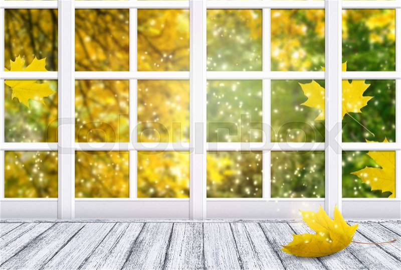 Room interior with window and yellow maple leaf lying on wooden table in Shabby Chic style. Autumn sunny day with golden autumnal trees and shiny flying sparkles outside. Empty place for decoration, stock photo