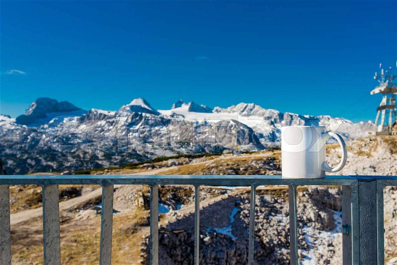 Hot cup of coffee overlooking the mountain, delicious break on top of alps, stock photo