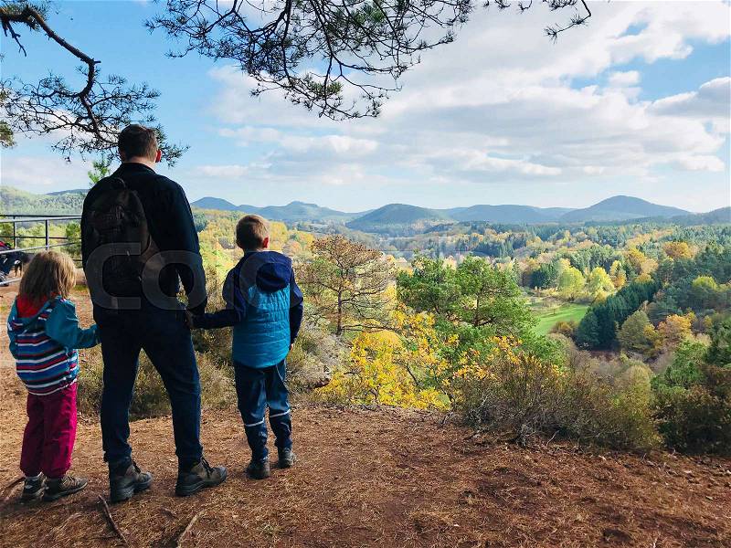 Family hike in natural autumn forest in Rheinland Pfalz, stock photo