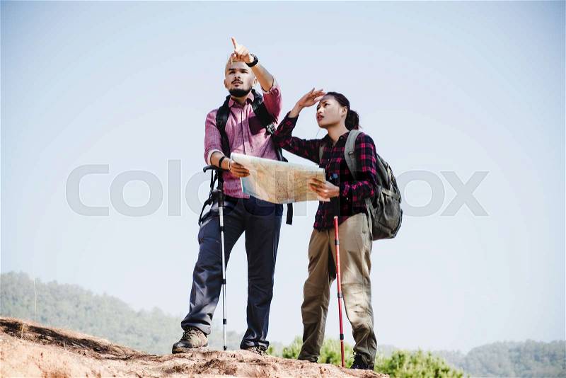 Young couple tourists with map in the park. Adventure, stock photo