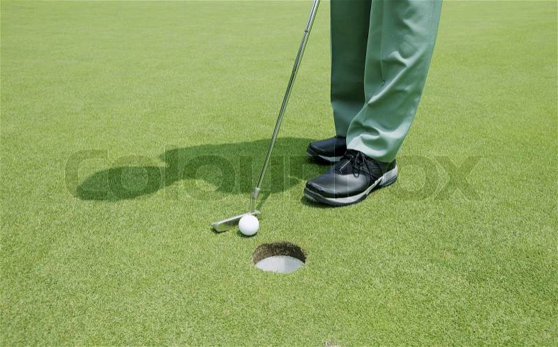 Golfer putting, stock photo