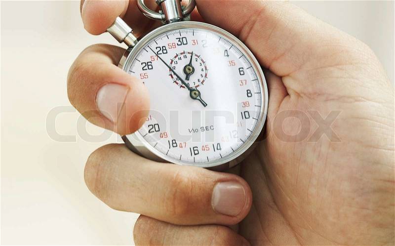 Hand holding a silver stop-watch, stock photo