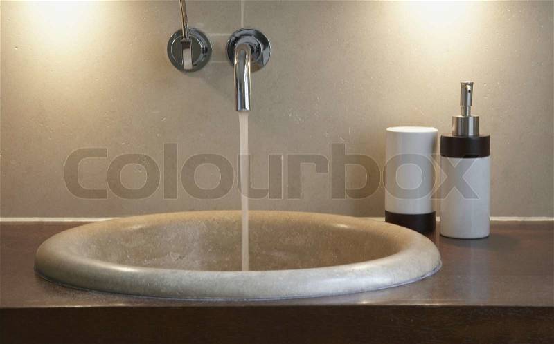 Bathroom sink with faucet on can be used as background, stock photo