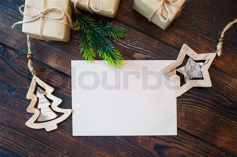 Stylish branding mockup to display your artworks. Cute vintage christmas new year gifts, star, tree mock up on wooden background, stock photo