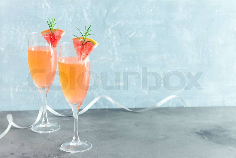 Mimosa festive drink - Champagne cocktail Mimosa with Grapefruit and Rosemary for Christmas party, copy space, stock photo