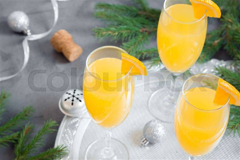 Mimosa festive drink for Christmas - Champagne cocktail Mimosa with Orange juice for Christmas party, copy space, stock photo