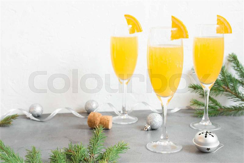 Mimosa festive drink for Christmas - Champagne cocktail Mimosa with Orange juice for Christmas party, copy space, stock photo