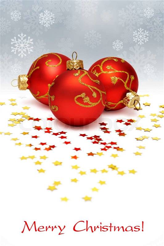 Christmas postcard with three red balls and golden conffeti, stock photo