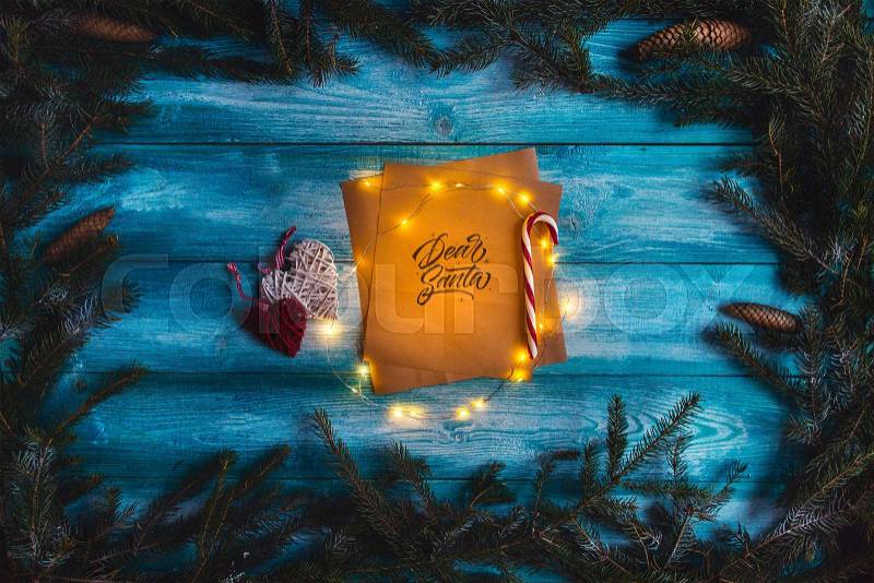 Letter to Dear Santa on a blue wooden table in the Christmas spirit, stock photo
