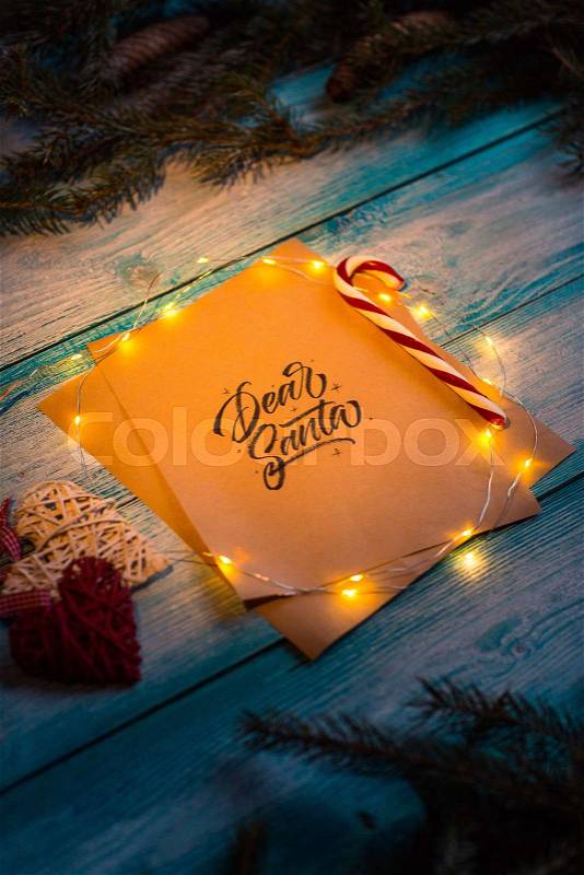 Letter to Dear Santa on a blue wooden table in the Christmas spirit, stock photo