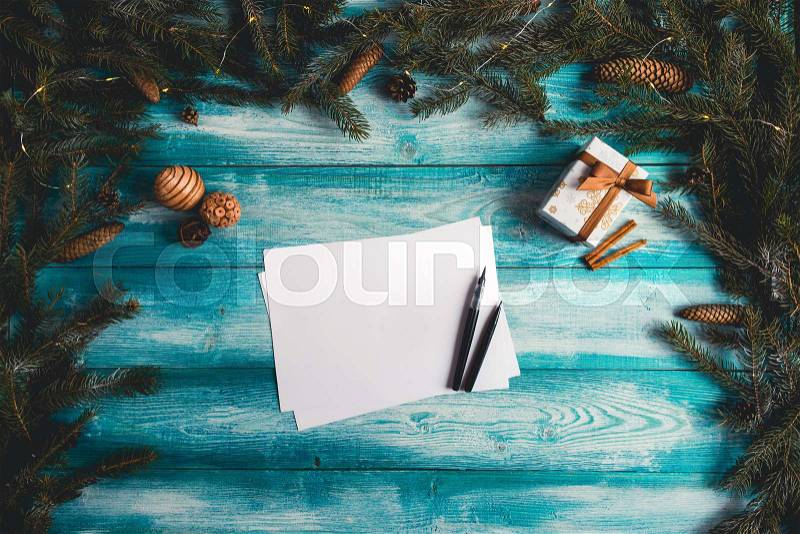 Blank sheet of paper on a blue wooden table with Christmas items. Christmas concept. , stock photo