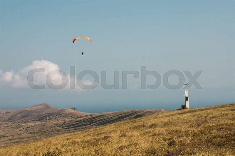 Person flying on paraplane sky with clouds on background, stock photo