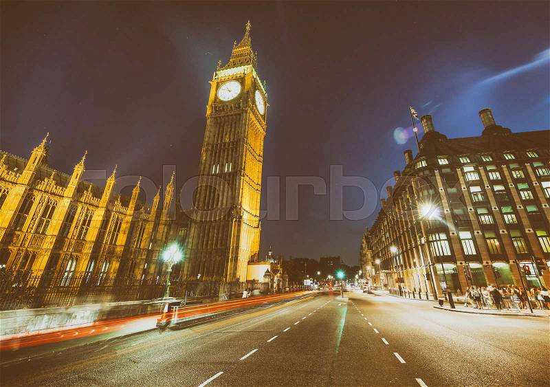 Westminster Palace and Big Ben at night from Westminster Bridge with car light trails - London, stock photo