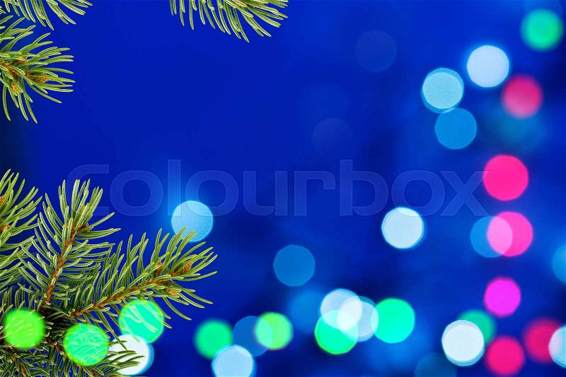Blue Christmas Background with Christmas Twig and Unfocused Lights, stock photo