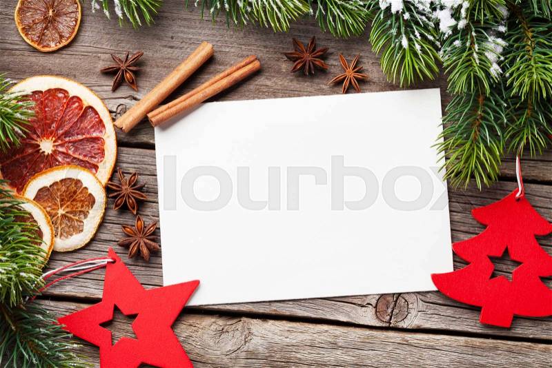 Christmas greeting card and food decor on wooden table with fir tree. Top view with copy space, stock photo