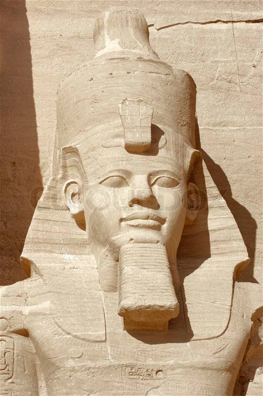 Architectural detail of the historic Abu Simbel temples in Egypt Africa showing a sculpture of Ramesses 2nd in sunny ambiance, stock photo