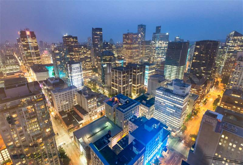 Night aerial view of Vancouver skyscrapers from city rooftop - British Columbia, Canada, stock photo