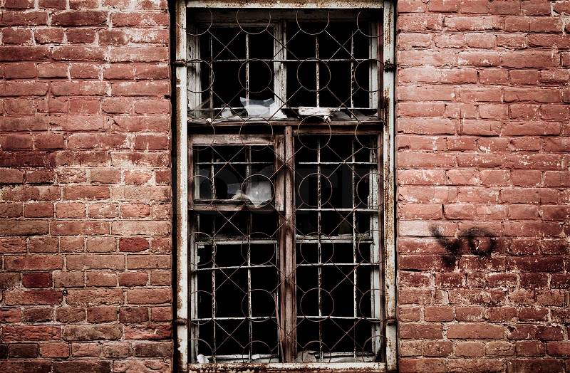 Wall of a deserted house with smashed window, stock photo