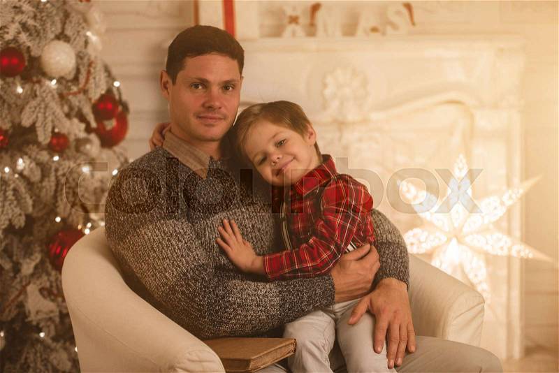 Father with son at home on Christmas evening, stock photo