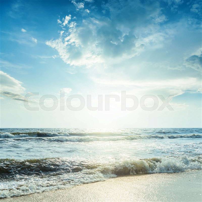 Sea with waves and blue sky in sunset, stock photo