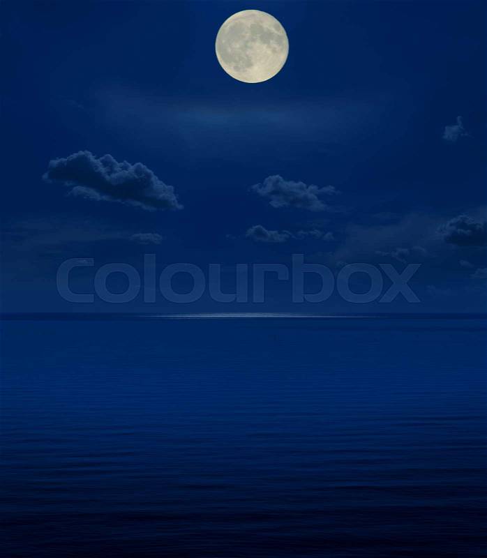 Full moon in night over sea, stock photo
