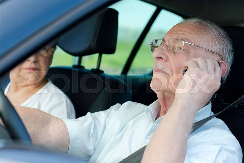 Senior man driver calling at the same time, stock photo