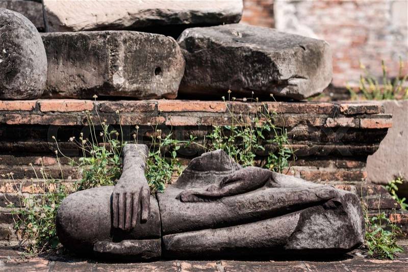 Ancient buddha statue were destroyed during the war,no head in Wat Mahathat, Ayutthaya province, Thailand, stock photo