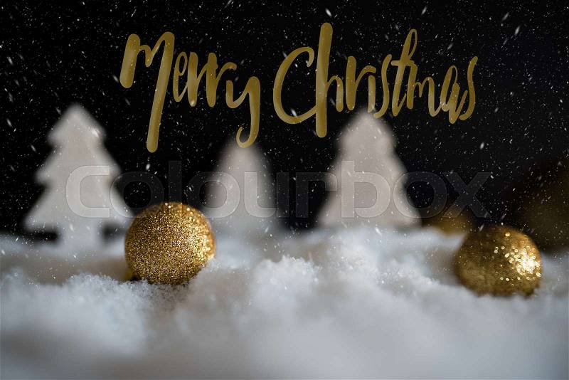 Snowy winter christmas greeting card with golden christmas tree ornaments, stock photo
