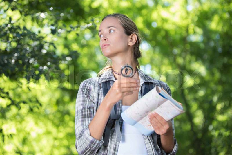 Female hiker deciding which path to take, stock photo