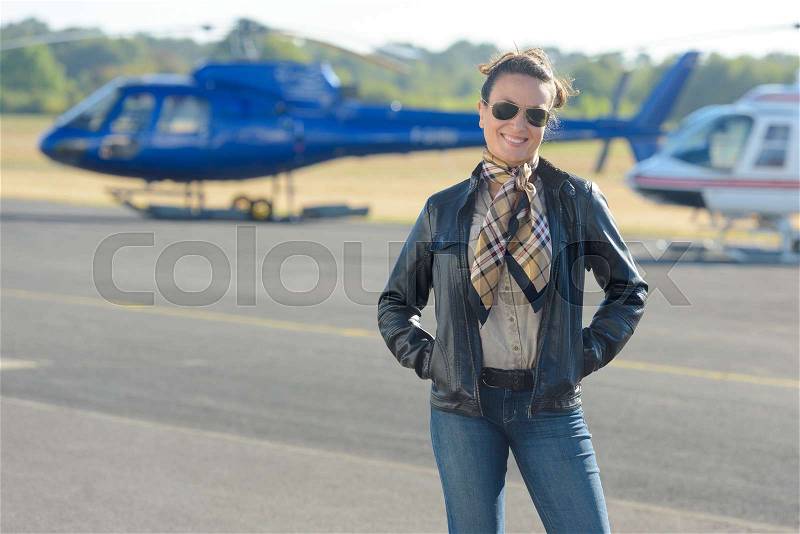 Portrait of woman at helicopter landing pad, stock photo