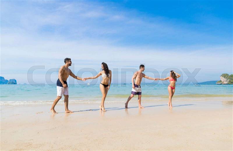 Two Couple On Beach Summer Vacation, Young People In Love Walking, Man Woman Holding Hands Sea Ocean Holiday Travel, stock photo