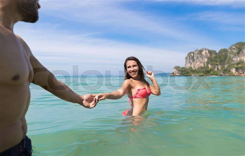 Couple On Beach Summer Vacation, Young People In Water, Woman Holding Man Hand Sea Ocean Holiday Travel, stock photo