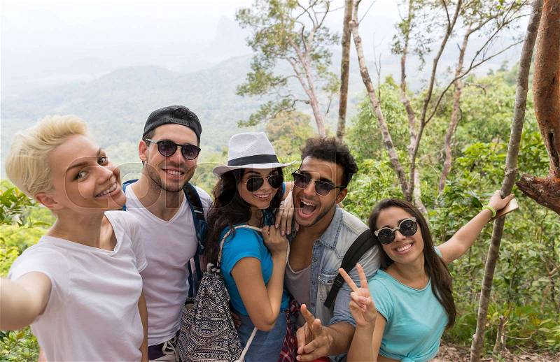 People Group Take Selfie Photo Over Beautiful Mountain Landscape, Trekking In Forest, Mix Race Young Men And Women Happy Smiling On Hike Tourists Adventure Activity, stock photo