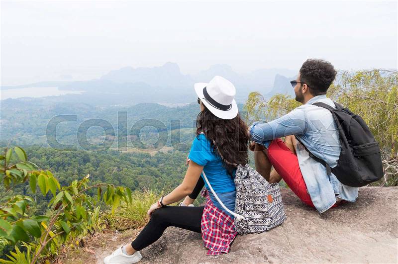 Tourist Couple With Backpack Sitting On Mountain Top Back Rear View Enjoy Beautiful Landscape, Young Man And Woman On Hike, stock photo