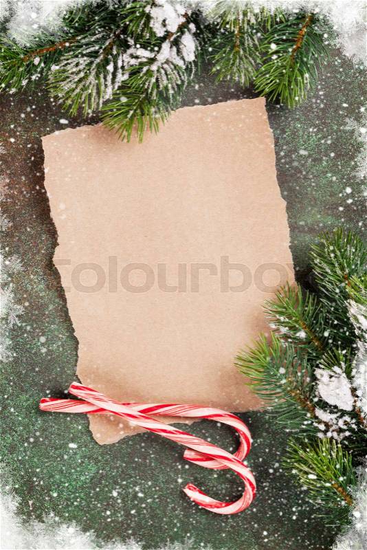 Piece of paper for christmas wishes and snow xmas tree. Top view with space for your text, stock photo