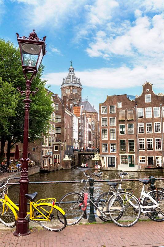 Bicycles on a bridge over the canals of Amsterdam, Netherlands in a summer day, stock photo