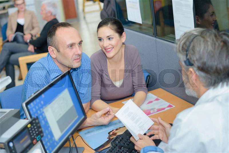 Couple talking with a transcriptionist, stock photo