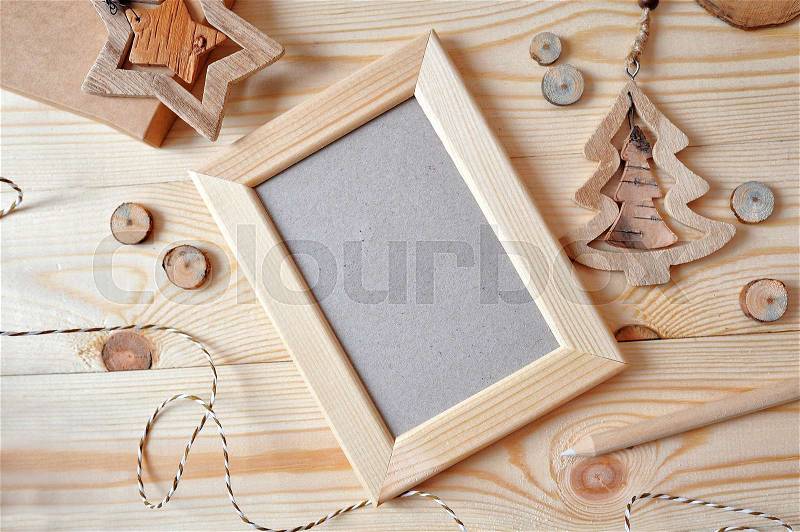 Christmas background with a wooden frame and a star and a Christmas tree. Flat lay, top view photo mockup, stock photo