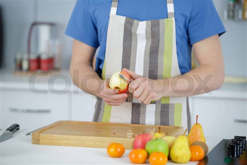 Man peeling a fruit, stock photo