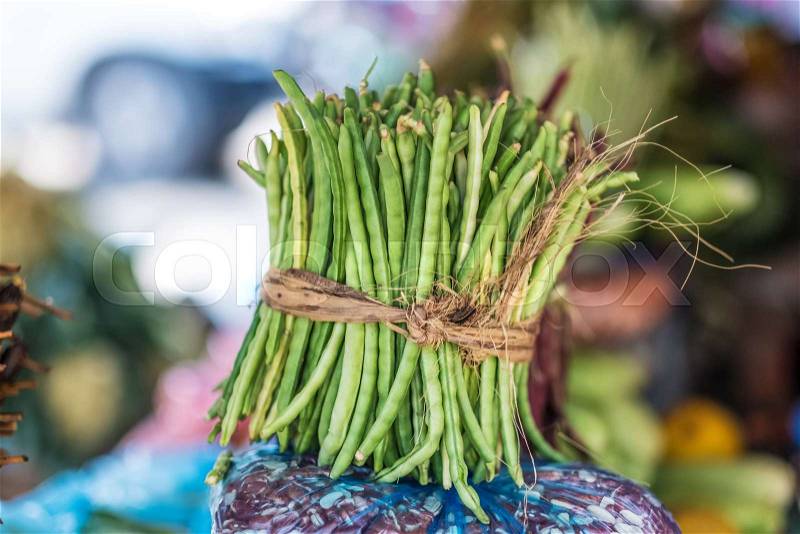 Bundle of fresh green beans on street market, stock photo
