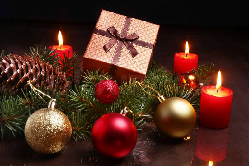 Christmas decoration with gift boxes, red candles, christmas tree and colorful balls. Selective focus, stock photo