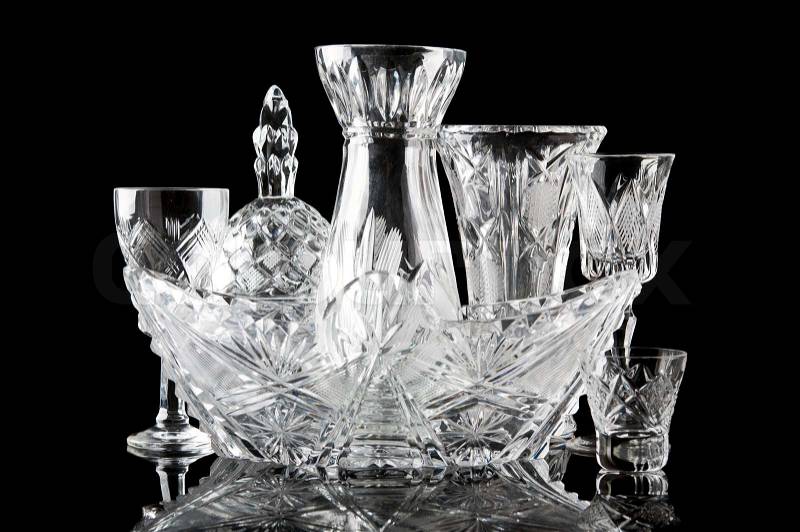 Collection of crystal dishes isolated on a black background, stock photo