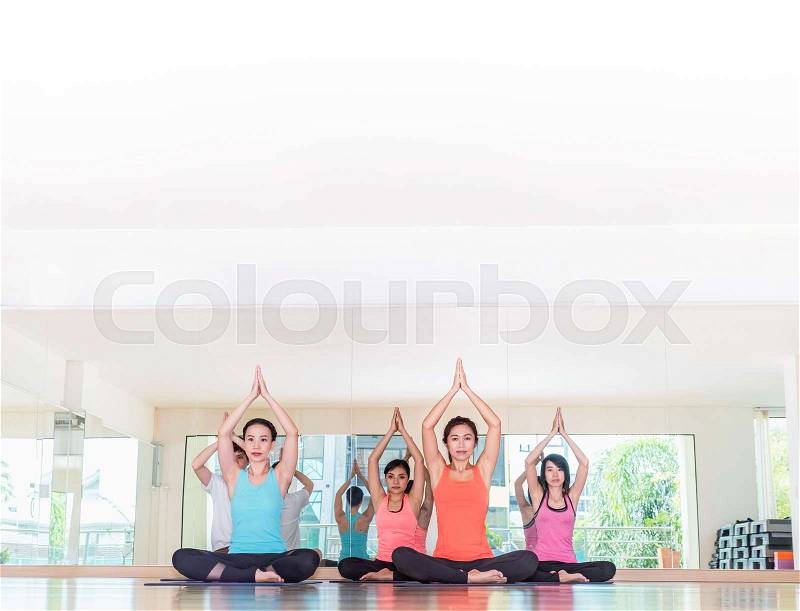 Yoga class in studio room,Group of people doing seated tree pose with calm relax emotion,Meditation pose,Wellness and Healthy Lifestyle, stock photo