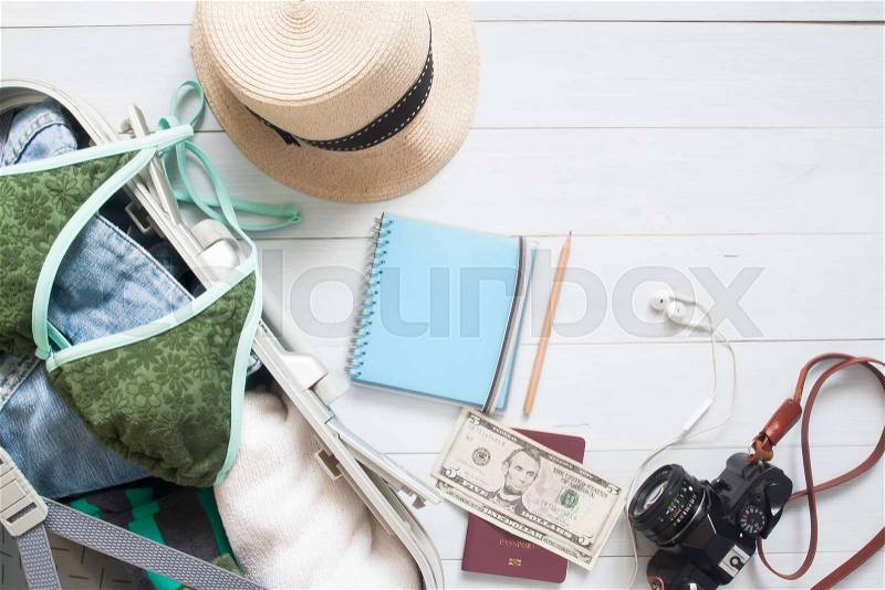 Overhead view of woman\'s essentials in luggage suitcase, Summer vacation, Travel concept, stock photo