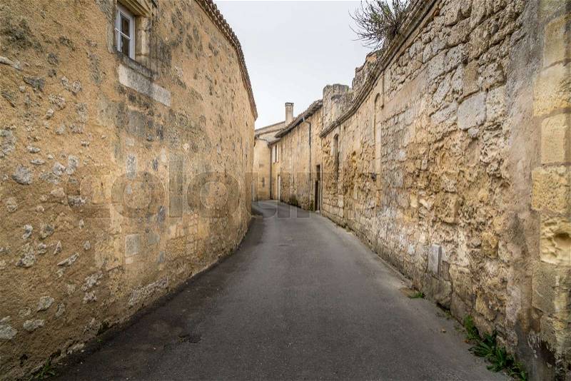 Ancient street made of stone named Rue de la Port Saint-Martin, in Saint-Emilion, France, stock photo