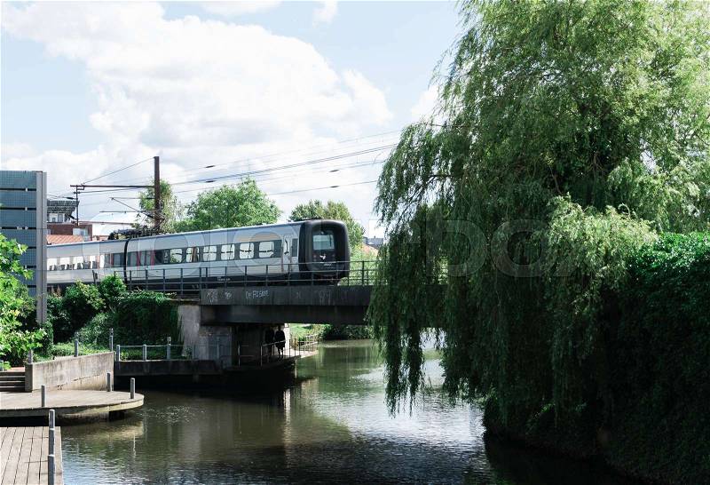 Local train crosses a canal on a bridge in Aarhus, stock photo